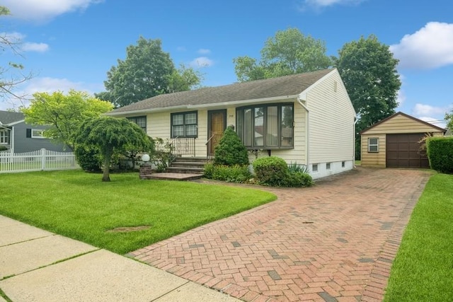 709 Seabury Ave, Franklin Square, NY 11010 - view of front of house with an outbuilding, decorative driveway, and a garage