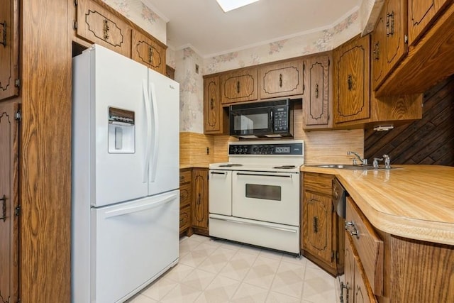 709 Seabury Ave, Franklin Square, NY 11010 - kitchen featuring white appliances, light countertops, and brown cabinets