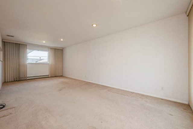 709 Seabury Ave, Franklin Square, NY 11010 - spare room with a baseboard radiator, light carpet, and recessed lighting