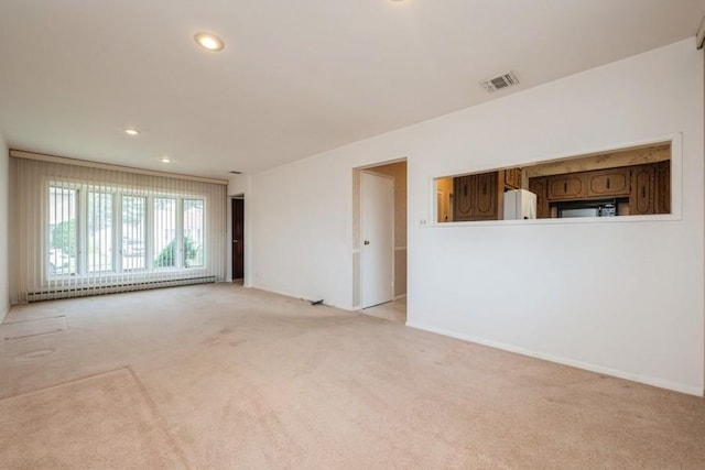 709 Seabury Ave, Franklin Square, NY 11010 - unfurnished room with baseboard heating, carpet, and recessed lighting