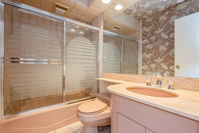 709 Seabury Ave, Franklin Square, NY 11010 - bathroom featuring vanity, bath / shower combo with glass door, and wallpapered walls