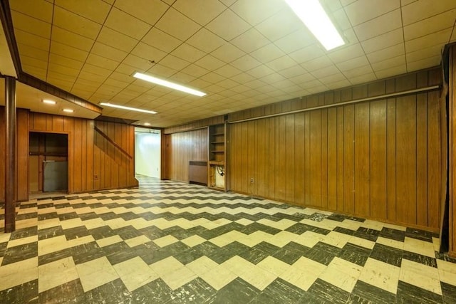 709 Seabury Ave, Franklin Square, NY 11010 - finished below grade area with light flooring, wood walls, and stairs