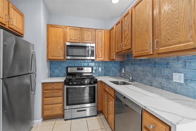 1410 Half Moon Bay Dr, Croton-On-Hudson, NY 10520 - kitchen with appliances with stainless steel finishes, decorative backsplash, light stone countertops, and light tile patterned floors