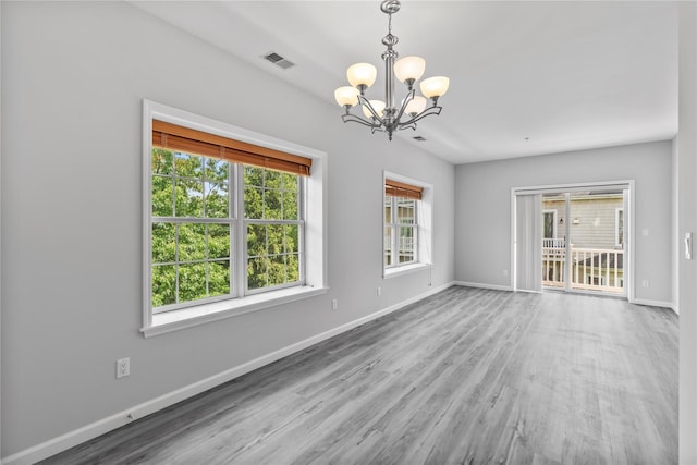 1410 Half Moon Bay Dr, Croton-On-Hudson, NY 10520 - spare room with a chandelier and wood finished floors