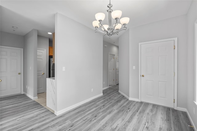 1410 Half Moon Bay Dr, Croton-On-Hudson, NY 10520 - unfurnished dining area featuring a chandelier and light wood-style flooring
