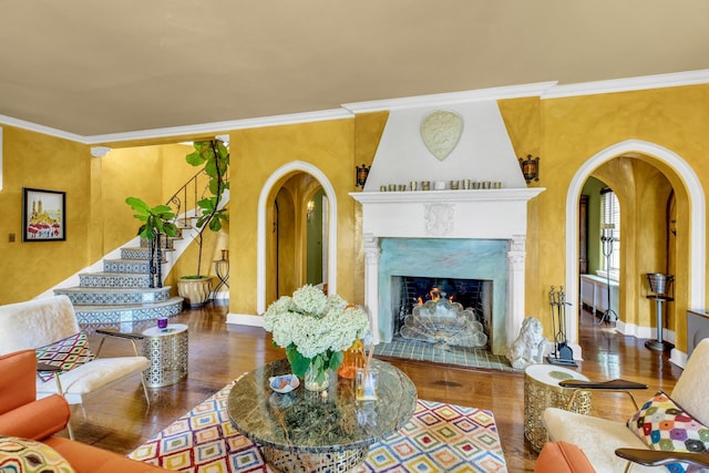 259 Lakeview Ave W, Brightwaters, NY 11718 - living area with arched walkways, wood finished floors, crown molding, a fireplace, and stairs