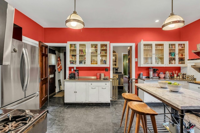 259 Lakeview Ave W, Brightwaters, NY 11718 - kitchen with freestanding refrigerator, white cabinets, decorative light fixtures, and glass insert cabinets