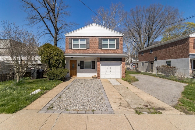 57 7th St, Pelham, NY 10803 - view of front of home featuring asphalt driveway, brick siding, and a garage