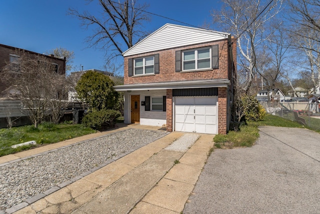 57 7th St, Pelham, NY 10803 - view of front facade with brick siding, driveway, and an attached garage