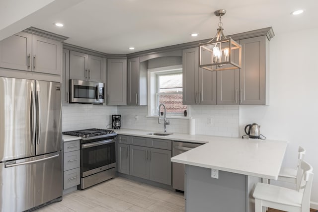 57 7th St, Pelham, NY 10803 - kitchen featuring appliances with stainless steel finishes, gray cabinetry, a peninsula, and recessed lighting