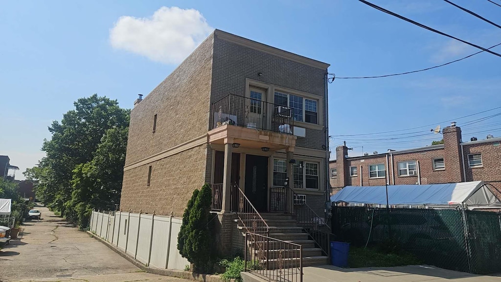 57-12 153th St, Flushing, NY 11355 - view of front of home featuring a balcony and brick siding