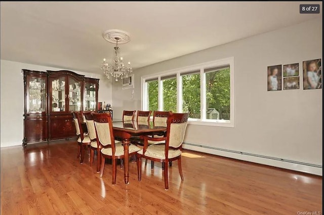 6 Schevchenko Pl, Monsey, NY 10977 - dining space featuring a baseboard heating unit, a chandelier, and wood finished floors