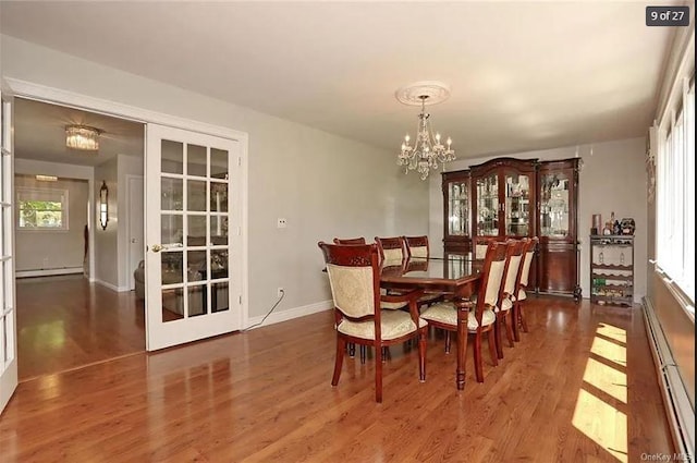 6 Schevchenko Pl, Monsey, NY 10977 - dining space with a baseboard heating unit, a chandelier, and wood finished floors