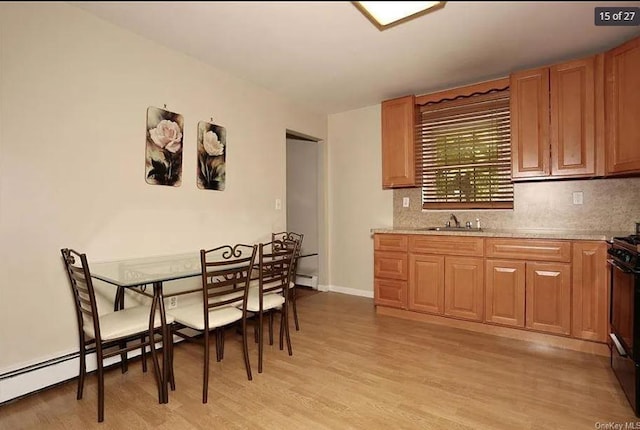 6 Schevchenko Pl, Monsey, NY 10977 - kitchen with light wood-style flooring, tasteful backsplash, and a baseboard heating unit