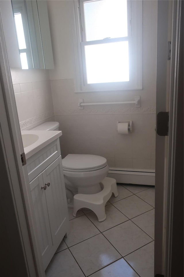 6 Schevchenko Pl, Monsey, NY 10977 - bathroom with a baseboard radiator, healthy amount of natural light, vanity, tile walls, and tile patterned floors