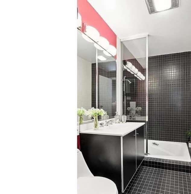 8 W 65th St Unit 5A, New York Manhattan, NY 10023 - bathroom featuring vanity, tile patterned floors, and tiled shower / bath