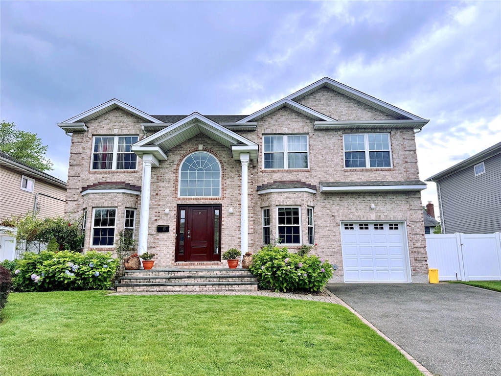 15 Southwood Cir, Syosset, NY 11791 - traditional-style house featuring brick siding, driveway, and an attached garage