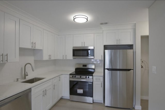 227 Springmeadow Dr Unit E, Holbrook, NY 11741 - kitchen featuring stainless steel appliances, white cabinets, backsplash, and light stone counters