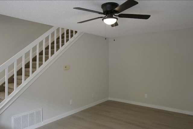 227 Springmeadow Dr Unit E, Holbrook, NY 11741 - unfurnished room featuring stairway, wood finished floors, a ceiling fan, and a textured ceiling