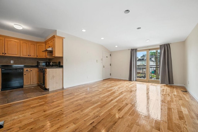 16407 Goethals Ave, Jamaica, NY 11432 - kitchen with black appliances, light wood-style flooring, decorative backsplash, dark countertops, and under cabinet range hood