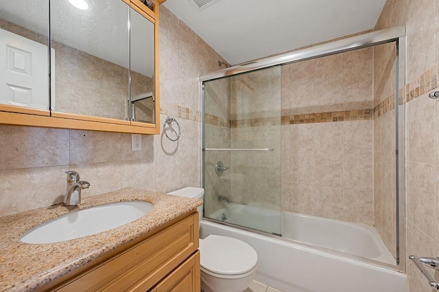 16407 Goethals Ave, Jamaica, NY 11432 - bathroom with tile walls, shower / bath combination with glass door, and vanity