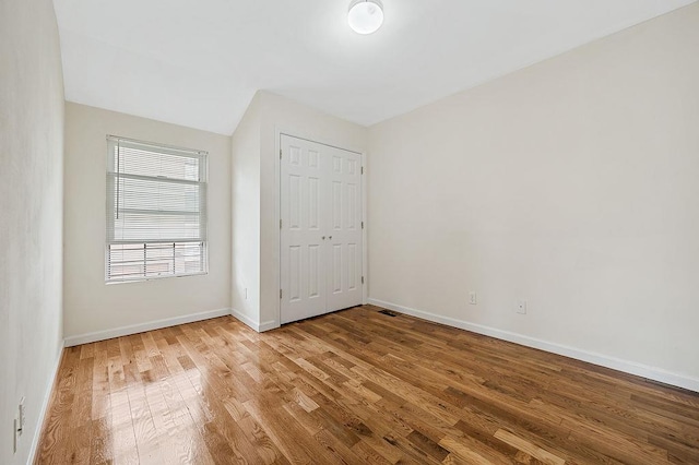 16407 Goethals Ave, Jamaica, NY 11432 - unfurnished bedroom featuring wood finished floors and a closet