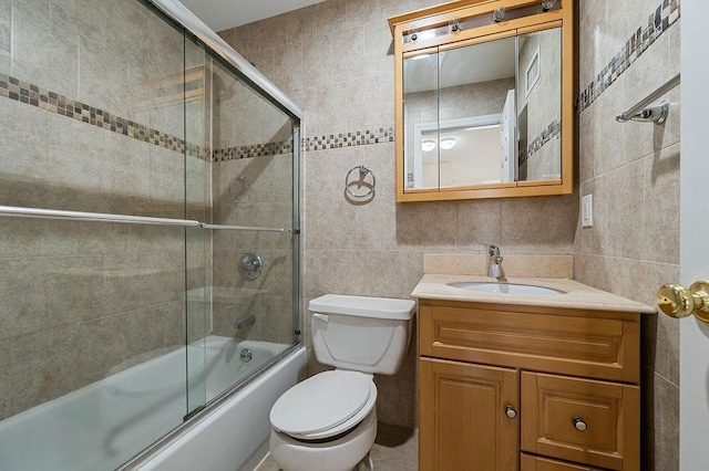 16407 Goethals Ave, Jamaica, NY 11432 - full bathroom featuring tile walls, shower / bath combination with glass door, and vanity