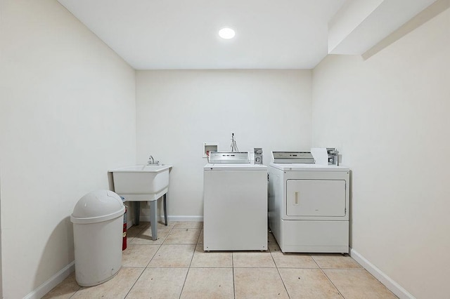16407 Goethals Ave, Jamaica, NY 11432 - laundry area with washing machine and clothes dryer, light tile patterned floors, and recessed lighting