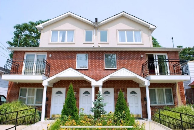 16407 Goethals Ave, Jamaica, NY 11432 - traditional home with a balcony, brick siding, and stucco siding