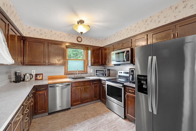 278 Fort Van Tyle Rd, Port Jervis, NY 12771 - kitchen featuring appliances with stainless steel finishes, light countertops, wallpapered walls, and light flooring