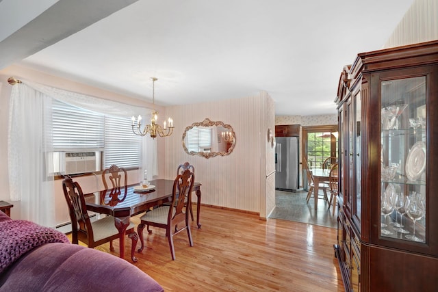 278 Fort Van Tyle Rd, Port Jervis, NY 12771 - dining room featuring wallpapered walls, light wood finished floors, a chandelier, and cooling unit