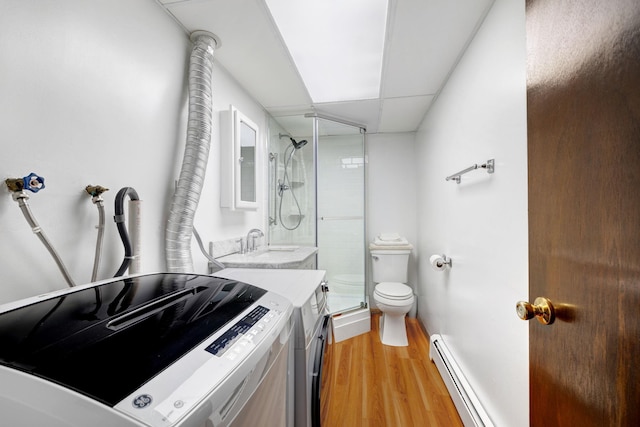 278 Fort Van Tyle Rd, Port Jervis, NY 12771 - bathroom with a baseboard heating unit, wood finished floors, a shower stall, and washer and clothes dryer