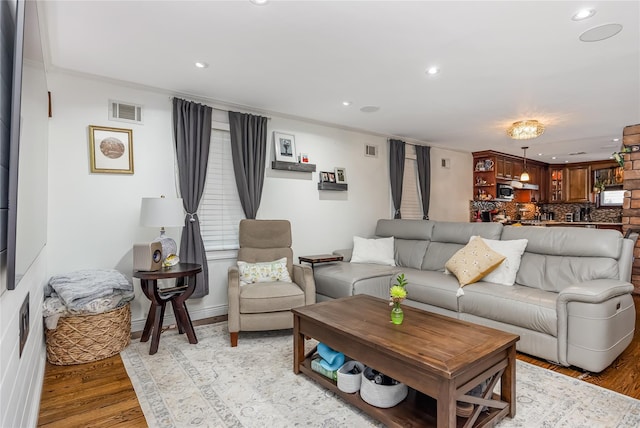 487 Court Ave, Cedarhurst, NY 11516 - living area with light wood-type flooring, recessed lighting, and crown molding