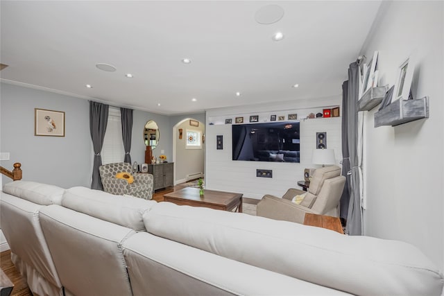 487 Court Ave, Cedarhurst, NY 11516 - living room featuring arched walkways, baseboard heating, crown molding, recessed lighting, and wood finished floors