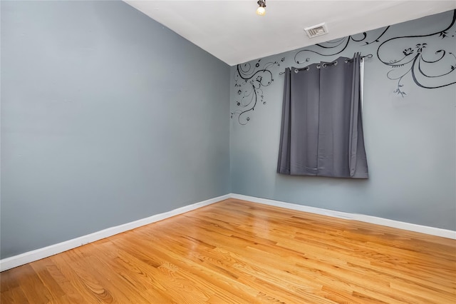 487 Court Ave, Cedarhurst, NY 11516 - spare room with vaulted ceiling and wood finished floors