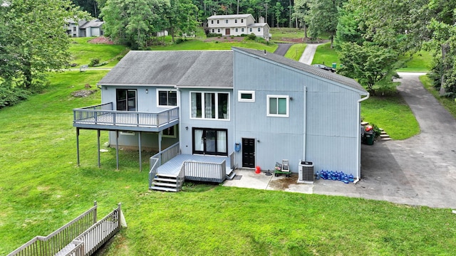 49 Flower Rd, Hopewell Junction, NY 12533 - rear view of property with a wooden deck, a yard, and a shingled roof