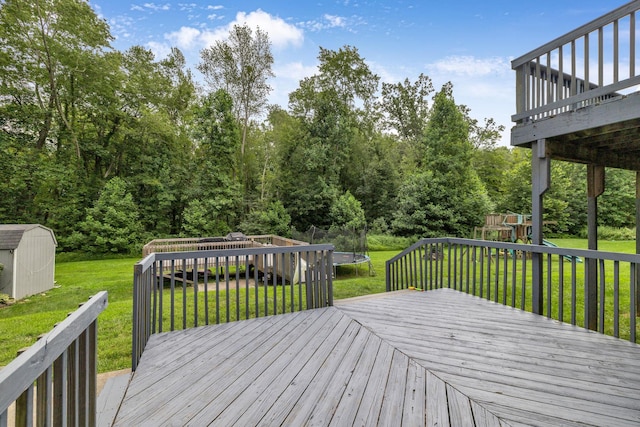 49 Flower Rd, Hopewell Junction, NY 12533 - deck with a trampoline, a storage unit, a playground, and a lawn