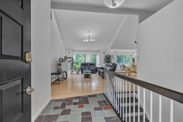 49 Flower Rd, Hopewell Junction, NY 12533 - entrance foyer with a chandelier, vaulted ceiling, and dark stone finish flooring