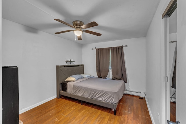 49 Flower Rd, Hopewell Junction, NY 12533 - bedroom featuring a baseboard radiator, wood finished floors, and a ceiling fan