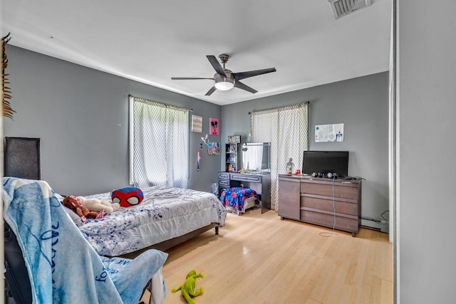 49 Flower Rd, Hopewell Junction, NY 12533 - bedroom with wood finished floors, ceiling fan, and a baseboard heating unit