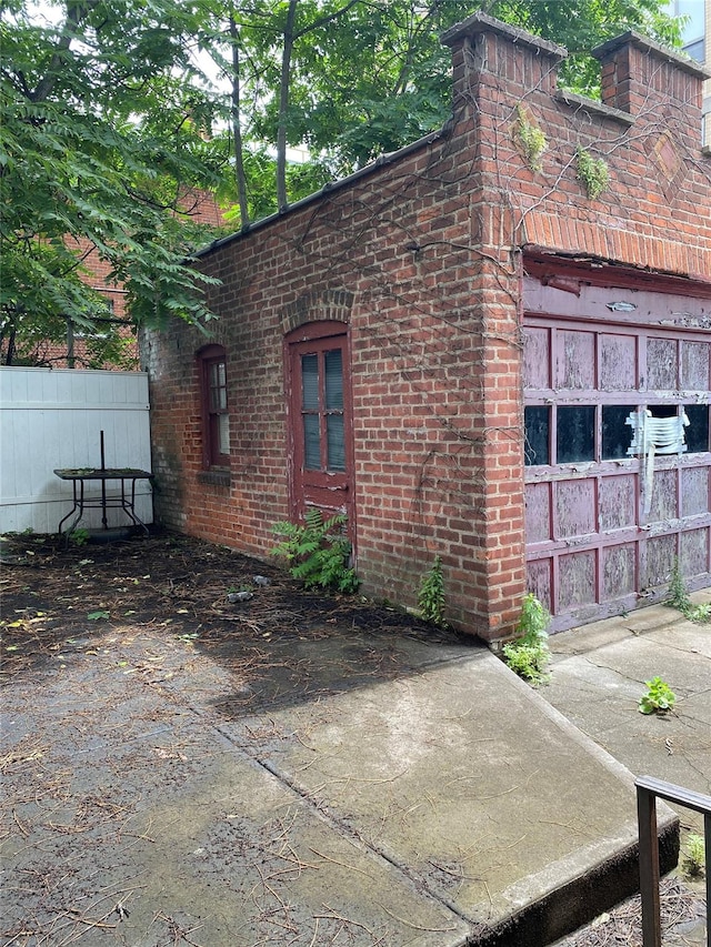 1624 Seddon St, Bronx, NY 10461 - view of side of property featuring brick siding, a garage, and concrete driveway