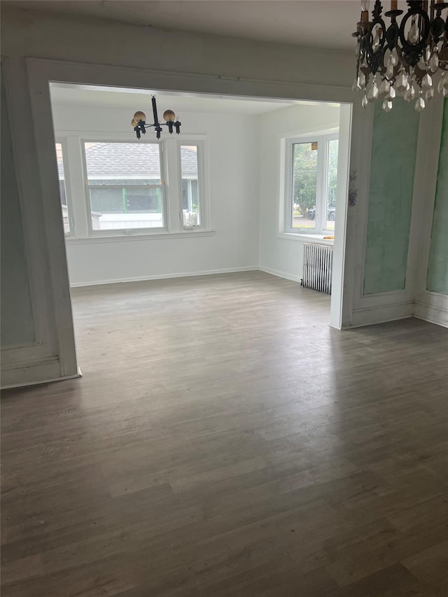 221 E Dean St, Freeport, NY 11520 - empty room featuring a chandelier, radiator heating unit, and wood finished floors