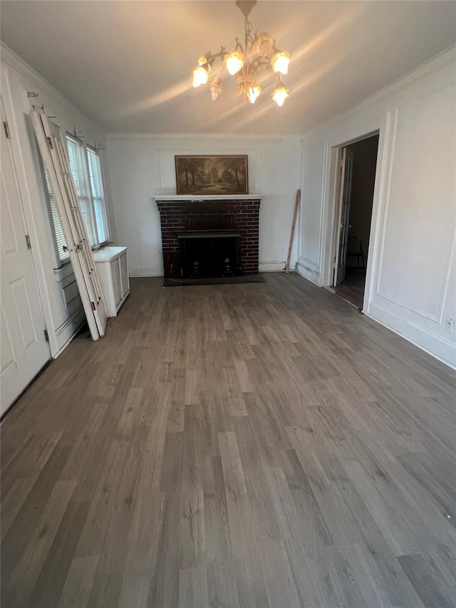 221 E Dean St, Freeport, NY 11520 - unfurnished living room featuring a chandelier, wood finished floors, a fireplace, and ornamental molding