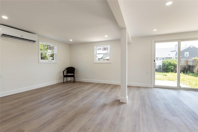 37 Martha St, Freeport, NY 11520 - below grade area with an AC wall unit, healthy amount of natural light, recessed lighting, and light wood-style floors