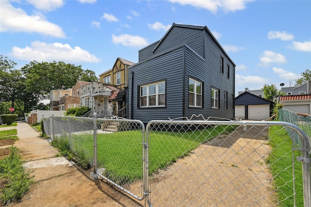 234-16 134th Rd, Laurelton, NY 11422 - view of front of property with a fenced front yard, a gate, and a detached garage