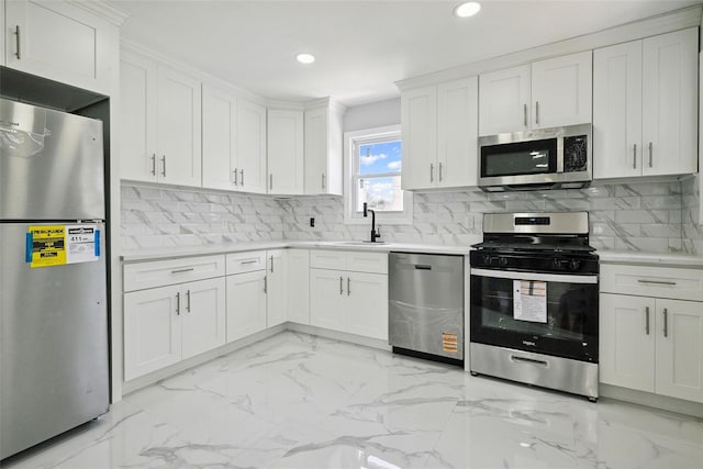 234-16 134th Rd, Laurelton, NY 11422 - kitchen featuring stainless steel appliances, recessed lighting, light countertops, white cabinets, and light marble finish flooring
