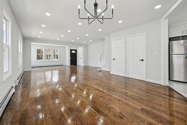 234-16 134th Rd, Laurelton, NY 11422 - unfurnished living room with a baseboard heating unit, a chandelier, recessed lighting, wood finished floors, and stairs