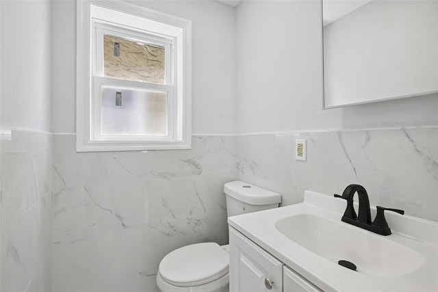 234-16 134th Rd, Laurelton, NY 11422 - half bathroom featuring tile walls, vanity, and a wainscoted wall