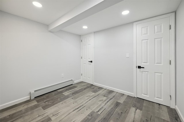 234-16 134th Rd, Laurelton, NY 11422 - spare room with baseboard heating, wood finished floors, and recessed lighting