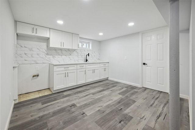 234-16 134th Rd, Laurelton, NY 11422 - kitchen with white cabinetry, backsplash, light wood-style floors, and recessed lighting